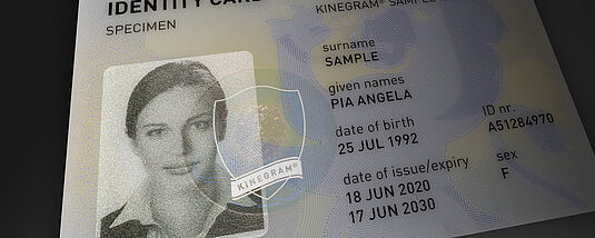 KINEGRAM Primary Image Protection Close-up image of a sample passport's data page, focusing on the portrait, which is secured against manipulation with a KINEGRAM Primary Image Protection feature.